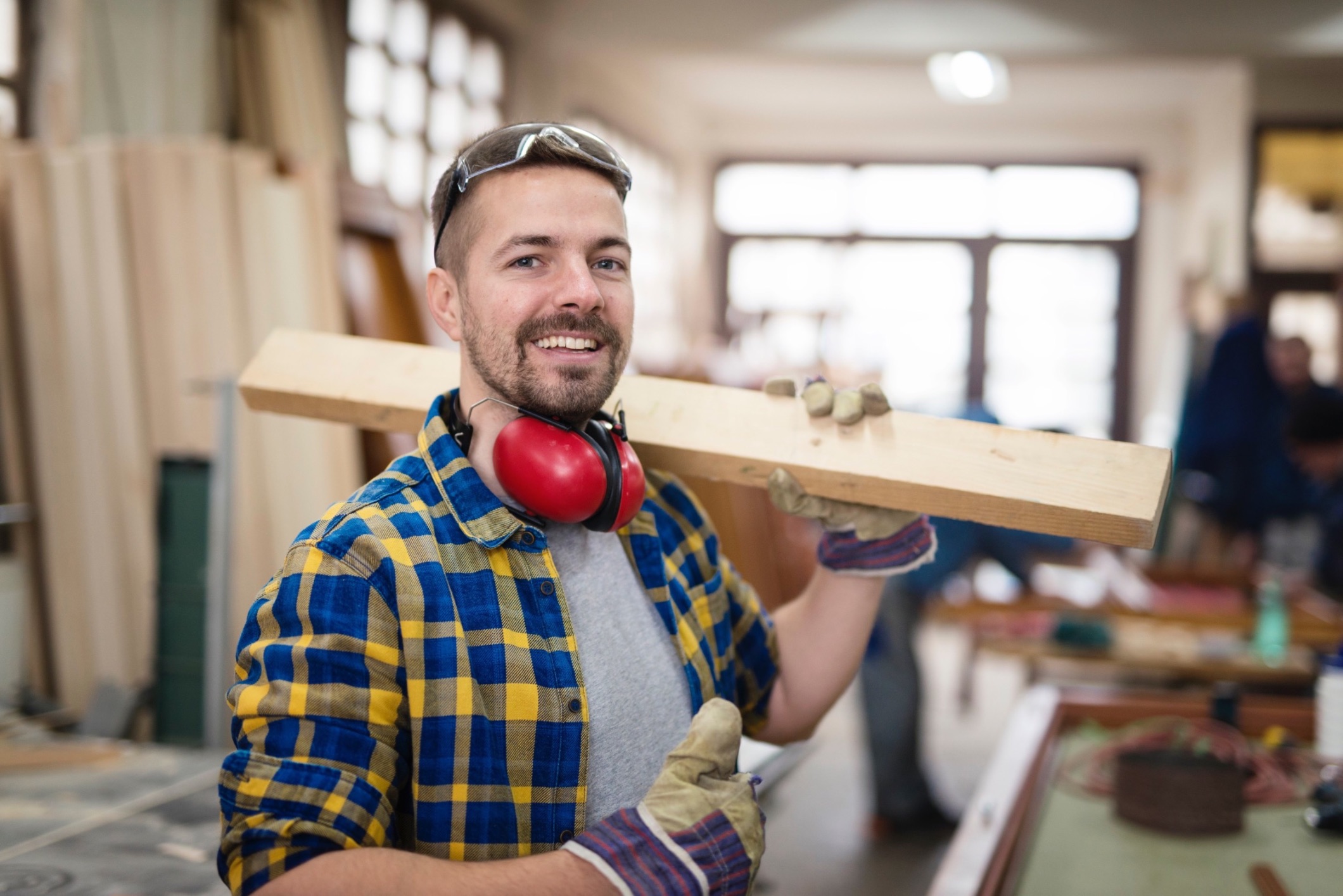 happy smiling carpenter holding wood material thumbs up his carpentry workshop 2 2 2 2
